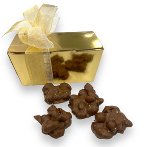 200 grams of peanut rocks with sea salt in a golden box